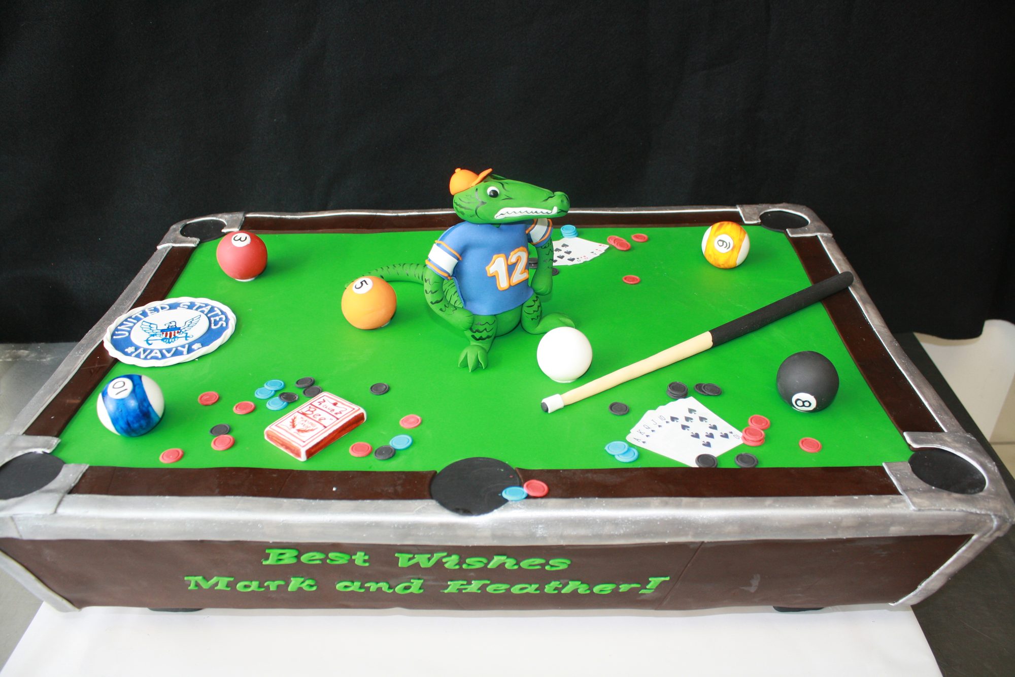 Sculpted pool table cake with a sugar alligator
